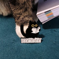 Booktrovert cat pin with a cat reading a book