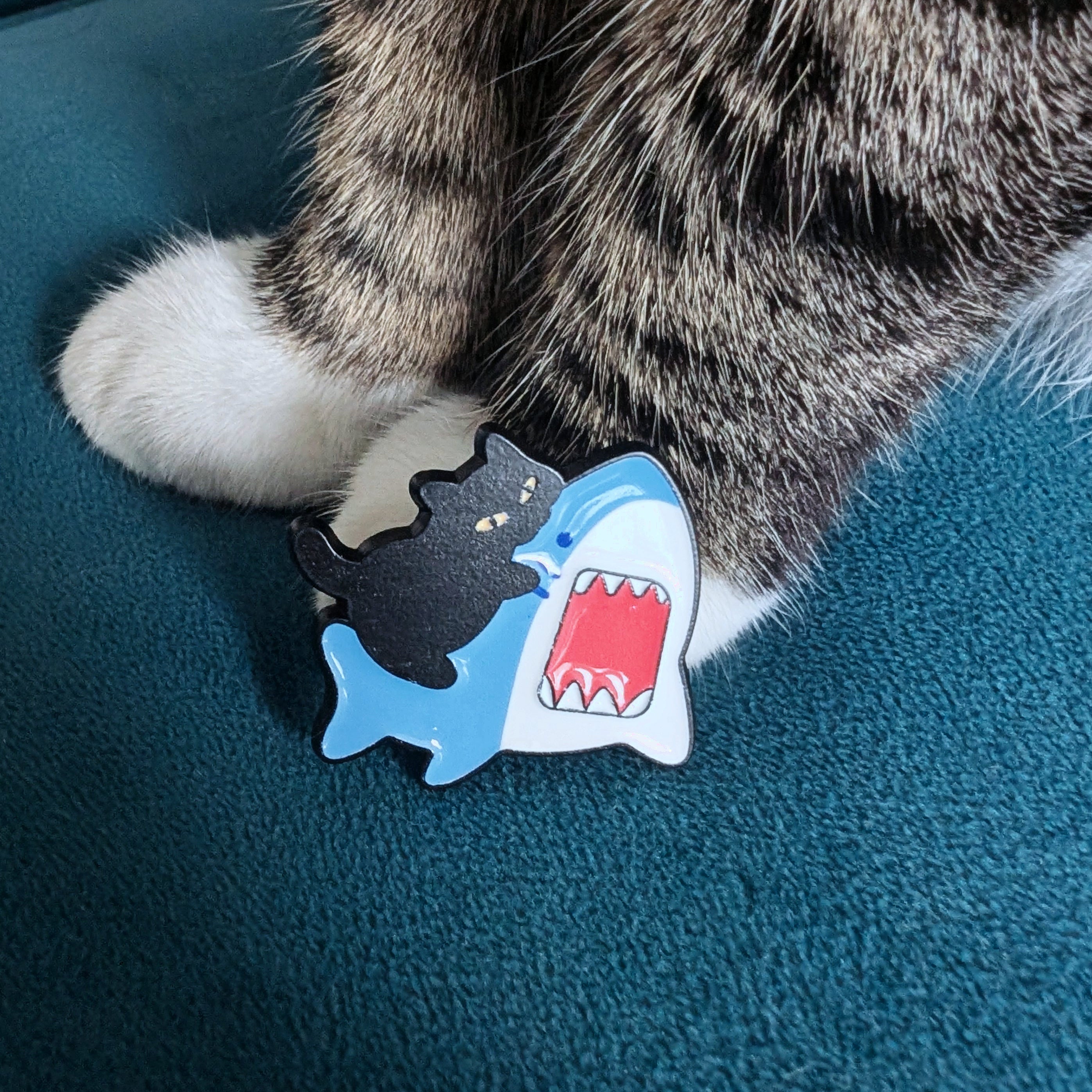 Cat biting shark enamel pin — funny cat and shark design