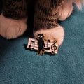 Black cat with treble clef and musical notes enamel pin