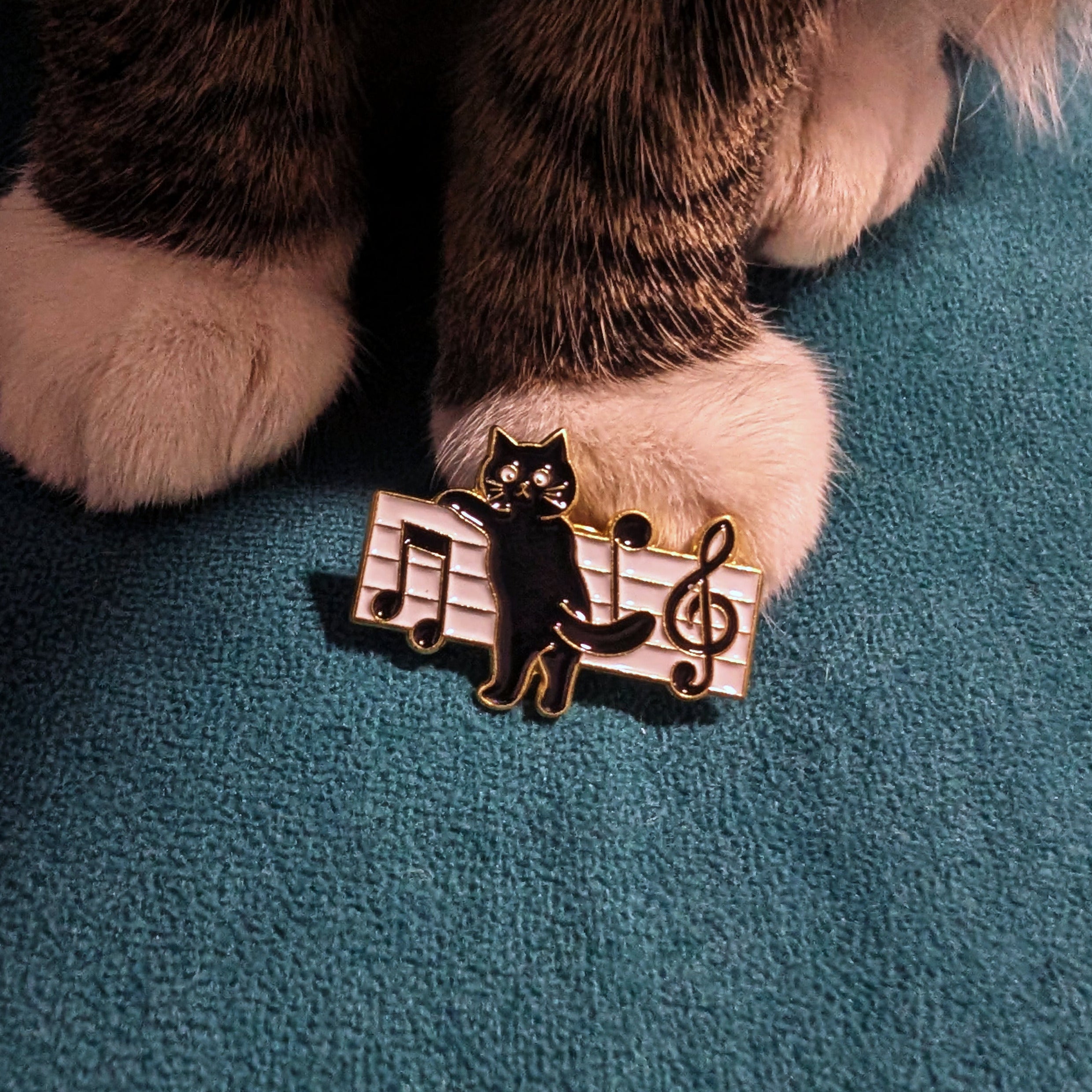 Black cat with treble clef and musical notes enamel pin