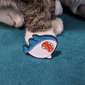 Round, chubby cartoon shark enamel pin
