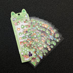 A pack of cute green frog-themed stickers fanned out. 