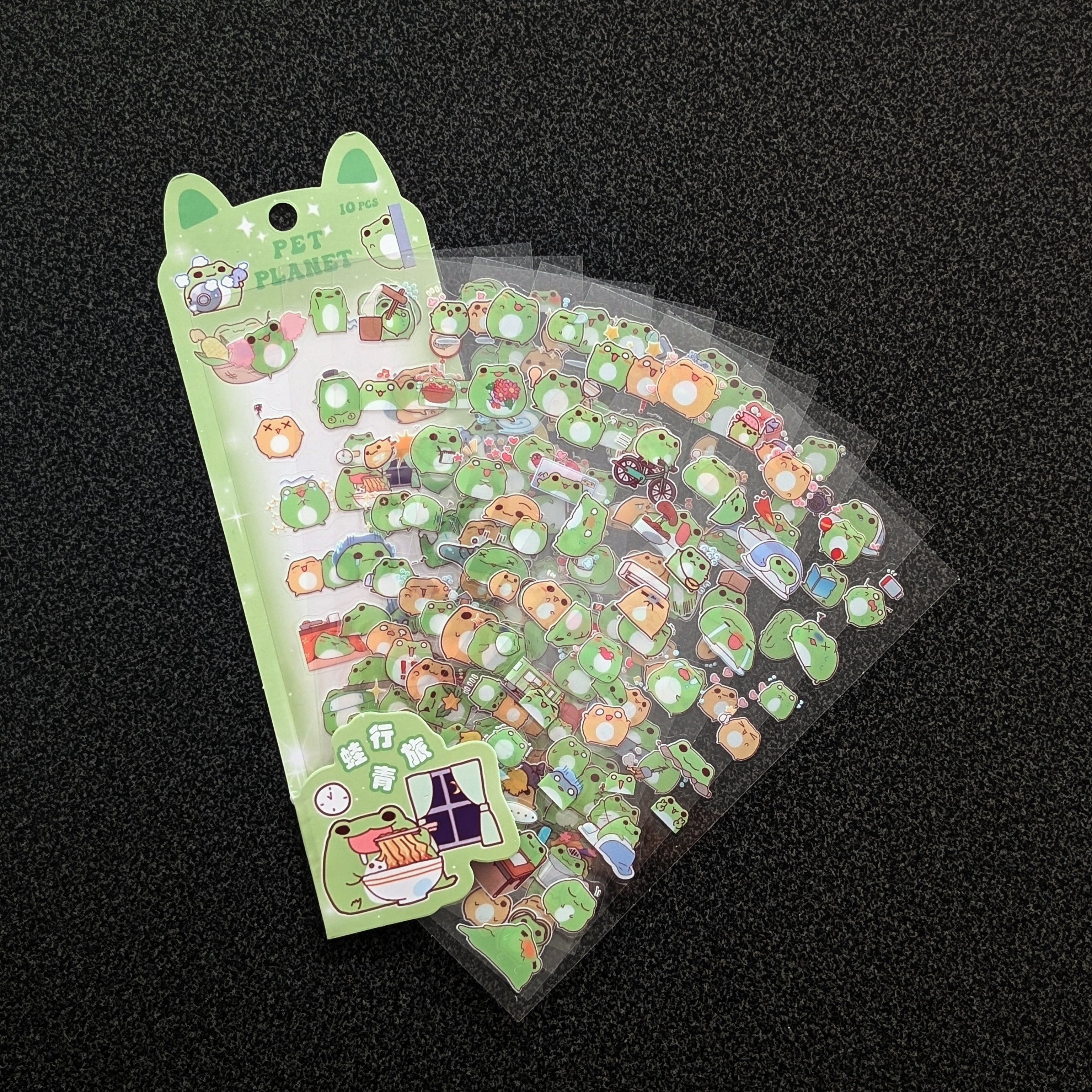 A pack of cute green frog-themed stickers fanned out. 